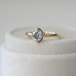 Oval Brilliant cut diamond ring in yellow gold on jewelery box quarter view