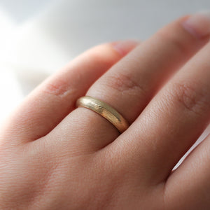 Textured Edge Gold Band on hand