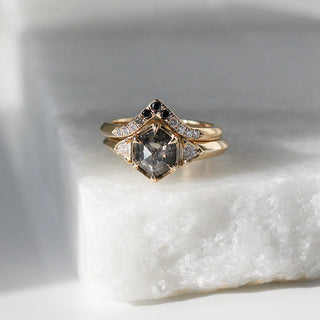 Black and Salt and Pepper Diamond Point Band stacked with hexagon diamond ring on marble quarter view