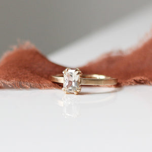 White Sapphire Gold Ring on orange fabric quarter view