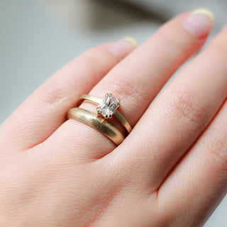 White Sapphire Gold Ring stacked with textured wide band on hand