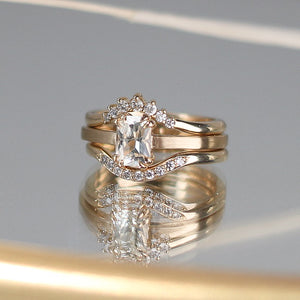 White Sapphire Ring paired with 2 diamond stacking bands being reflected in the mirror  