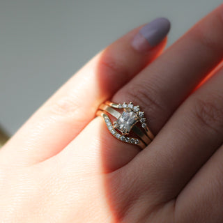 White Sapphire Gold Ring paired with 2 diamond stacking bands on hand in light 