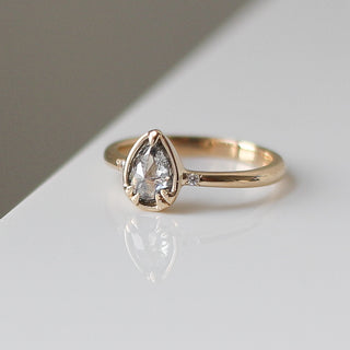Pear cut diamond ring in yellow gold with reflection side quarter view