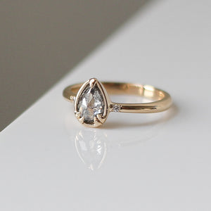 Pear cut diamond ring in yellow gold with reflection side quarter view