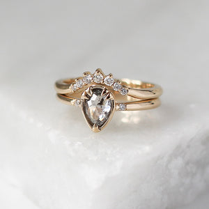 Sahara Diamond Crown in Yellow Gold stacked with pear diamond ring on marble