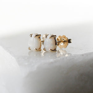 White Opal Pear Gold Studs side view on marble