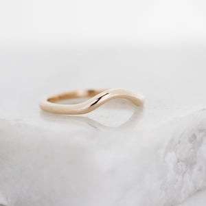 Wave Band in Yellow Gold quarter view on marble
