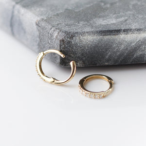 Diamond Hoops in Yellow Gold side profile view on grey stone