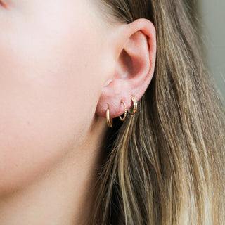 Smooth Hoops paired with braided and diamond cut hoops worn on ear