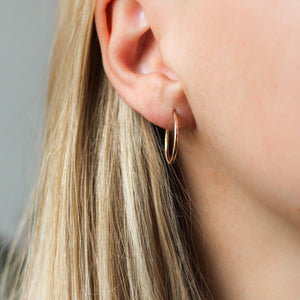 Everyday Hammered Hoops in yellow gold being worn
