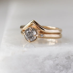 Point Band in Yellow Gold stacked with round diamond ring on marble quarter view