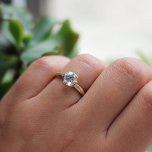 White Sapphire Gold Ring on hand with plants