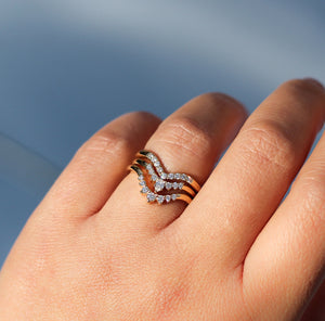 Sahara Diamond v shaped band stacked with oval diamond bands on hand  