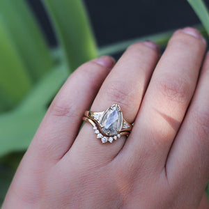 Sahara Diamond v shaped band stacked with pear diamond ring on hand