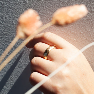 Faceted Wide Band on hand in light with plants above