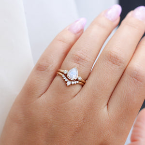 Pear icy diamond ring with curved diamond band on hand