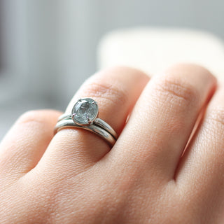 Classic Textured Thin Band stacked with oval diamond ring on hand