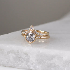 Pear Diamond Point Band stacked with round diamond ring on marble