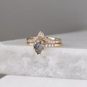 Pear Diamond Point Band stacked with pear diamond ring on marble