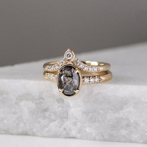 Pear Diamond Point Band stacked with oval salt and pepper diamond ring on marble