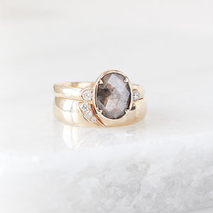 Shooting Star Diamond Ring stacked with oval salt and pepper diamond ring quarter view on marble 