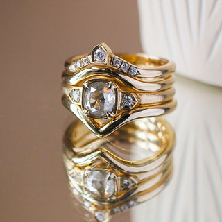 Point Band in Yellow Gold stacked with large diamond ring and shield crown band with reflections