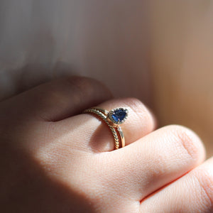 Twisted Thin Gold Band stacked with sapphire gold ring on hand