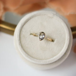 Pear diamond ring in yellow gold in ring box