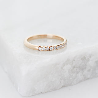 Diamond pave straight band quarter view on marble
