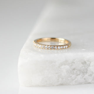 Diamond pave straight band side detail view on marble