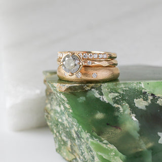 Diamond pave straight band with round diamond ring with wide large band stacked on green marble