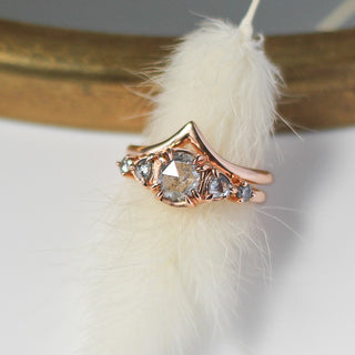 Point Gold Band stacked with 5 diamond ring over feather top view