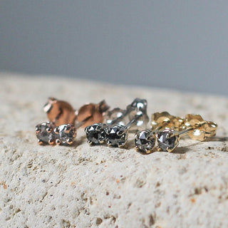 Salt & Pepper Diamond Studs in white, yellow and rose gold on stone
