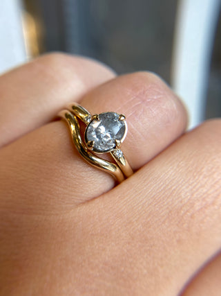 Wave Gold Band stacked with oval diamond ring on hand close up view